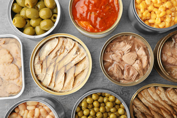 Wall Mural - Open tin cans with different food on table