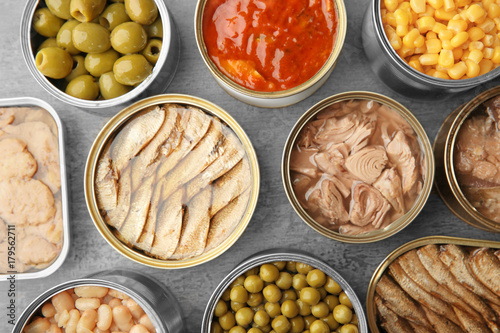 Open tin cans with different food on table Canvas