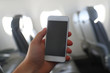 © makedonski2015 - The man using mobile phone on the airplane while traveling