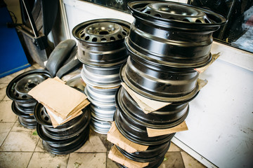 Wall Mural - group of car wheels in garage service repair shop, steel automobile disc for replacement