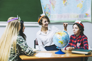 Teacher woman happy young students is a lesson in the form of games in the classroom