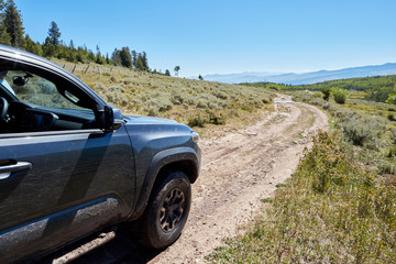 4WD vehicle driving through mountain scenery