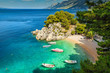 Tropical bay and beach with motorboats, Brela, Dalmatia region, Croatia