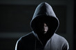 Mysterious african man with hood in darkness
