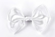 White bow tie on white background. White accessory for girls hair isolated on white background.