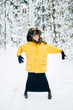 © benevolente - Odd strange young bizarre fancy lonely girl making weird poses in winter snowy forest on weekend. Fashionable mad kinky woman in glasses and warm trendy clothes relaxing outdoor. Crazy headdress.