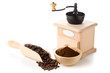 Coffee beans in wooden scoop and ground coffee with coffee bean grinder
