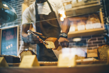 Black man works in pastry shop.