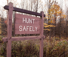 A "HUNT SAFELY" Sign In The Woods In The Fall