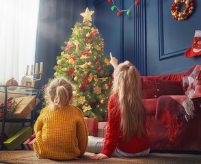 sisters near Christmas tree