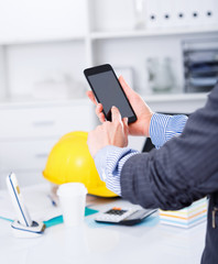 Hands of businesswoman using phone