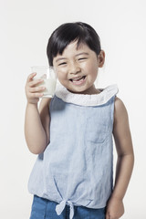 Wall Mural - Pretty asian girl hand holding a cup of milk with smile isolated white.