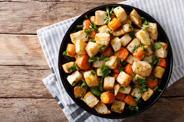 Wall Mural - Healthy food: baked celery root and carrots close-up on a table. Horizontal top view