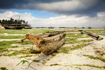 Wall Mural - Old wooden fishing boat on shores of the Indian Ocean