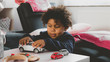 © supamotion - African American kid playing with toy car at home