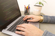 © artursfoto - Programming Work Time. Programmer Typing New Lines of HTML Code. Laptop and Hand Closeup. Working Time. Web Design Business Concept.