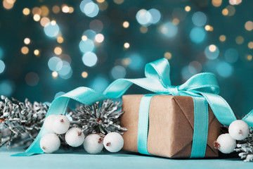 magic christmas background with gift box and snowy fir tree. greeting card with bokeh effect.
