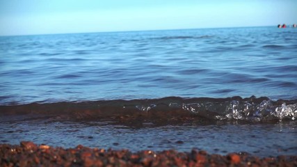 Wall Mural - the waves roll on the pebble beach Slowmotion 240 FPS