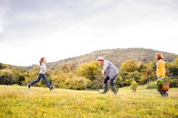 Senior couple with grandaughter in nature.