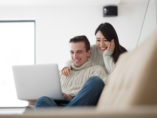 Wall Mural - multiethnic couple using laptop computers