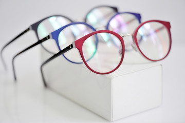 Wall Mural - Multicolored fashionable glasses on a white case