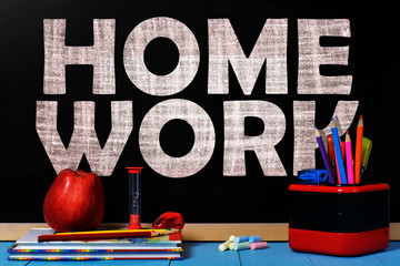 Wall Mural - Text Homework on black chalkboard with school accessories