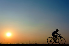 Silhouette Of Young Woman Cyclist On Sunset Sky With Riding Along The Prairie At Yellow Evening Horizon Sea Yellow Sunset Heaven Background Outdoor