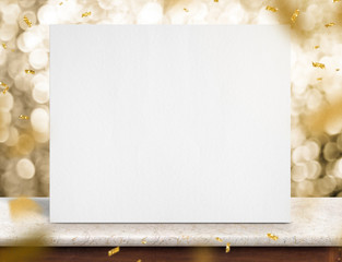 Poster - Blank white paper poster on marble table with gold sparkling confetti at gold bokeh lights at background,mock up template for adding text or content design,Holiday celebrate concept.