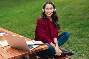 Poster - Portrait of an attractive smiling asian girl in headphones