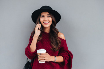 Sticker - Portrait of a smiling cheerful asian girl dressed in hat