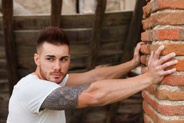 Sticker - Attractive guy next to a brick wall