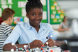 © highwaystarz - Female Pupil Using Molecular Model Kit In Science Lesson
