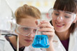 © highwaystarz - Female Pupil And Teacher Conducting Chemistry Experiment