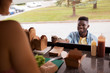 © Syda Productions - african american man buying wok at food truck