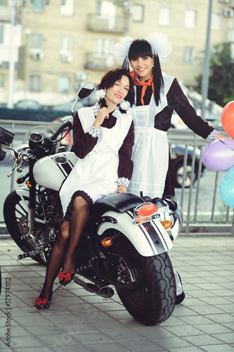 Two Beautiful Young Woman Hairstyle And Bows Outdoors With A