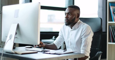 Happy young black man working use computer in office smile technology feeling pleasure african american businessman casual communication entrepreneur male successful person portrait smart business
