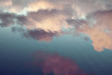 Fototapeta  - reflection of blue sky with white clouds in water, abstract background.