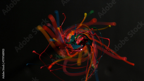 Fototapeta  Circular rainbow paint splattering towards camera