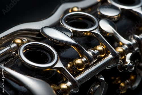 Fotomural Details of a clarinet with silver keys and golden sockets