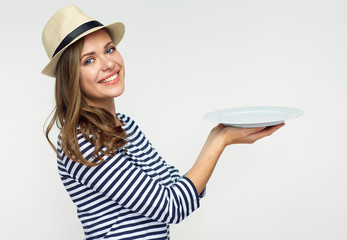 Wall Mural - smiling woman holding empty white plate.