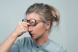 © Dmytro Flisak - Tired woman has eyes pain. Optician and eyeglasses