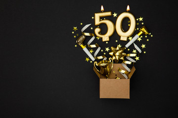 Wall Mural - Number 50 gold celebration candle and gift box background