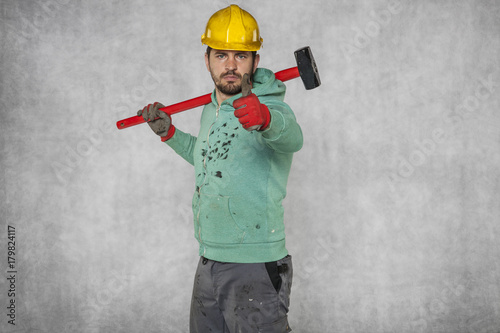Fotografie, Obraz happy worker with a hammer on his shoulder