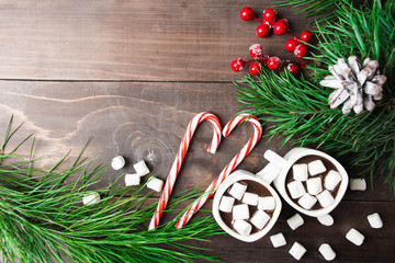 Hot chocolate with marshmallow with decorations over wooden table