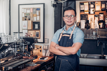 Poster - Male Barista cafe owner cross arms in store counter bar inside coffee shop, food and drink business start up