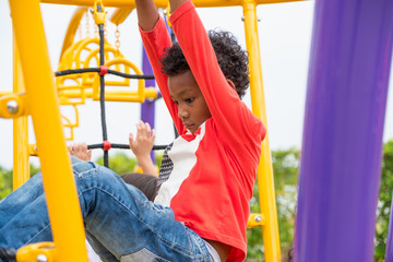 kid boy having fun to play on children's climbing toy at school playground,back to school activity.