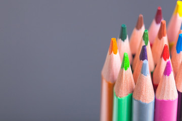 Wall Mural - The sharp tips of the pencils. Bright colored pencils. Colored pencils on grey background with selective focus