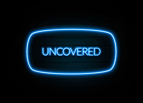 Uncovered  - colorful Neon Sign on brickwall