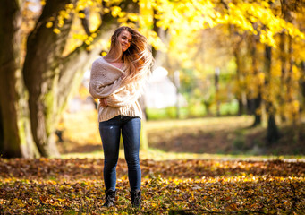 Wall Mural - Enjoy autumn happy woman on colorful fall background