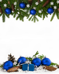 Christmas decoration  four-fifths with blue baubles, cones and gift on white background.